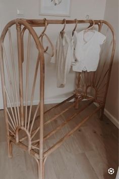 a bamboo clothing hanger in the corner of a room