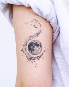 a woman's arm with a tattoo on it that shows the moon and stars