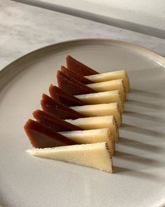 four pieces of fruit are arranged on a plate