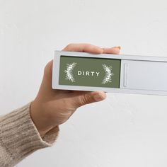 a person is holding up a card with the word dirty on it in front of them