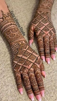 two hands with henna tattoos on them