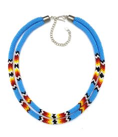 Introducing our stunning handmade beaded rope layered statement necklace in captivating cyan blue and fiery hues, meticulously crafted to add a touch of elegance and vibrancy to your ensemble. This unique piece boasts a length of 17 inches, adorned with a 4-inch extension chain for customizable wear, ensuring a perfect fit for any neckline. The mesmerizing color palette features a striking combination of cyan blue and fiery tones, creating a dynamic and eye-catching visual appeal. Each bead is expertly sourced from high-quality Czech beads, adding an artisanal touch to the design. The meticulous craftsmanship and attention to detail shine through, making this necklace a true work of art. The closure is secured with a classic hook and silver finish, providing both durability and a touch of Blue Beaded Multi-strand Layered Necklace, Blue Multi-strand Beaded Layered Necklace, Leon Outfit, Cyan Blue, Beaded Rope, Rope Necklace, Layered Necklace, Czech Beads, Blue Beads