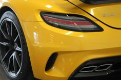 the rear end of a yellow sports car