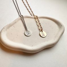 Subtle dainty necklace for ARMY. These are keepsake pieces that can be worn daily and can lasts for years and years. The charms are made in either high quality 925 sterling silver or 14k gold fill. The chains are durable stainless steel. Choose between BTS logo or Love Yourself Logo. Discs are approximately 0.5" CHAIN OPTIONS:Choose between cable chain or paperclip chain.Choose between gold or silver.Choose between 16" or 20" -------------- 🔨 I stamp each letter/design by hand with traditional Minimalist Sterling Silver Charm Necklaces, Minimalist Sterling Silver Charm Necklaces, Tarnish Resistant, Minimalist Sterling Silver Charm Necklace, Tarnish Resistant, Minimalist Sterling Silver Charm Necklace Tarnish Resistant, Minimalist Stainless Steel Necklaces With Charms, Dainty Stainless Steel Necklace With Charms, Sterling Silver Tarnish-resistant Charm Necklace As Gift For Her, Tarnish Resistant Sterling Silver Charm Necklace For Her, Minimalist Stainless Steel Charm Necklaces