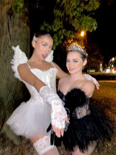 two women dressed in costumes posing for the camera