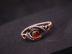 Adorn your fingers with the warm, golden glow of our Handmade Amber Copper Wire Wrapped Ring. Each ring is meticulously handcrafted with a beautiful amber gemstone and wrapped in intricate copper wire, creating a unique and stunning piece of jewelry. Available in any US size and made to order, this ring is the perfect addition to your collection or a thoughtful gift for someone special. Features: Material: Amber gemstone and copper wire Color: Warm golden amber with natural inclusions Design: In Wire Wrapped Rings Intricate, Copper Ring Jewelry For Anniversary, Gold Copper Round Ring, Oval Hand Wrapped Rings As A Gift, Oval Hand Wrapped Rings For Gift, Copper Wire Wrapped Rings As Gift, Round Copper Jewelry For Anniversary, Handmade Copper Promise Ring, Gold Copper Promise Ring