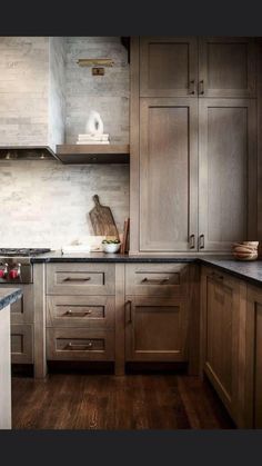 a kitchen with wooden cabinets and marble counter tops