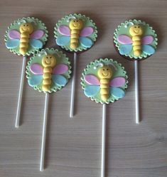 four honey bee lollipops sitting on top of each other