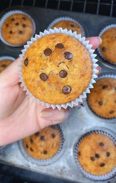 a person holding a muffin in their hand