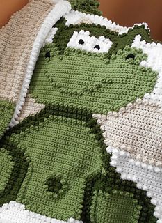 the crocheted blanket is made to look like kermik