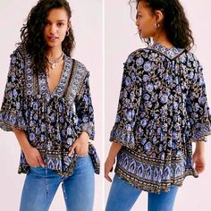 Embrace Your Inner Goddess In This Strikingly Beautiful Tunic From Free People, In An Exquisite Batik Floral Print Full Of Rich Blues, Camel Brown, Ivory & Black. Gorgeous As A Sexy Mini Dress Or Tunic Top Worn With Jeans. Full Of Intricate Details, It Features A Loose Flowy Silhouette, Deep V-Neckline With Self-Tie Closure, Crochet Inset, Drop Shoulders With Ruffle Details, Flared Sleeves With Wide Ruffles, Side Pockets & High-Low Hemline. 100% Viscose. Generously Sized. Approx. Bust 21, Length Black Bohemian Printed Blouse, Black Boho Print Tops For Spring, Spring Black Boho Print Tops, Black Bohemian Top With Boho Print, Black Bohemian Tops With Boho Print, Black Bohemian Blouse With Floral Print, Black Floral Print Festival Blouse, Black Floral Print Blouse For Festival, Embroidered Dress Boho