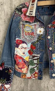 a jean jacket with patches and flowers on it