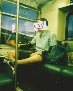 a man sitting on a train with his legs crossed