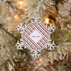 a snowflake ornament hanging from a christmas tree