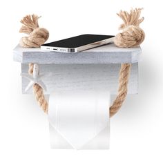 a cell phone sitting on top of a wooden shelf with rope wrapped around the edge