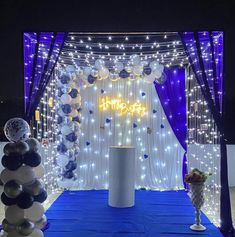 a decorated stage with balloons and lights