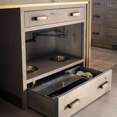 an open drawer in the middle of a kitchen