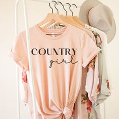 Country Girl T-shirt Black or White Print-country girl shirt- Country Shirt - Gift For Friend - Shirt Country girl - Country gift-country music shirt-Country T This classic unisex jersey short sleeve tee fits like a well-loved favorite. Soft cotton and quality print make users fall in love with it over and over again. These t-shirts have-ribbed knit collars to bolster shaping. The shoulders have taping for better fit over time. Dual side seams hold the garment's shape for longer.  .: 100% Airlume combed and ringspun cotton (fiber content may vary for different colors) .: Light fabric (4.2 oz/yd² (142 g/m .: Retail fit .: Tear away label .: Runs true to size Graphic Tee For Country Events With Short Sleeves, Short Sleeve Graphic Tee For Country Events, Summer Crew Neck Tops For Country Events, Summer Country Style Crew Neck Top, Crew Neck Tops For Country Events In Summer, Crew Neck Tops For Summer Country Events, Graphic Tee With Letter Print For Country Festivals, Country Style T-shirt For Spring Events, Country Style Short Sleeve Tops With Letter Print