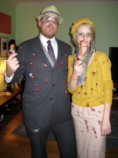 a man and woman dressed up as zombies