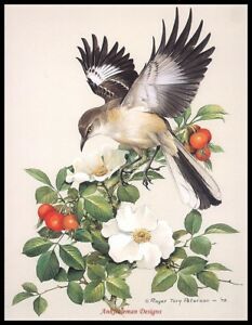 a bird sitting on top of a branch filled with flowers