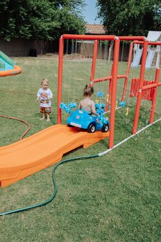 two small children playing in a play yard