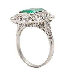 The Daphne ring was handmade in platinum and centers one natural Colombian emerald that weighs 2.70ctw which is surrounded by 76 old mine cut diamonds of H color and VS1 clarity that weigh 0.70ctw. This ring is currently size 7 and can be sized. Total weight: 6.3 grams/ 4dwt Ring measurement: 19mm by 16mm by 7mm Oval Emerald Ring With Pave Setting In Platinum, Silver Emerald Ring With Pave Setting, Platinum Emerald Ring With Pave Setting As Gift, Exquisite Emerald Cut Platinum Emerald Ring, White Gold Emerald-cut Ring With Pave Setting, Silver Emerald Cut Ring With Pave Setting, Octagon White Gold Emerald Ring With Halo Setting, Silver Platinum Emerald Ring With Pave Setting, White Gold Octagon Emerald Ring With Halo Setting