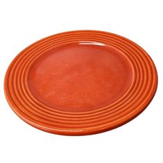 an orange plate on a white background