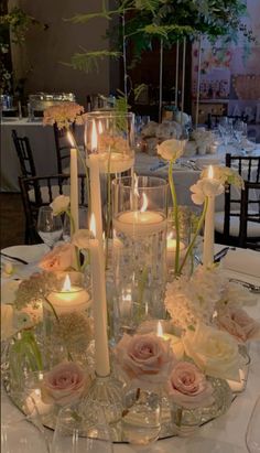 a table topped with lots of candles and flowers