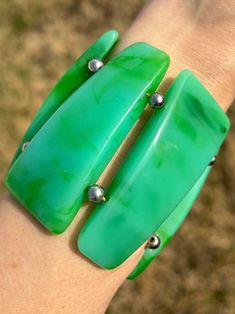 Vintage Green Marble Paneled Stretch Bracelet Faux Bakelite Band width 2.75in Band Opening 2in with Stretch Plastic 3.2oz This listing is for this exact item shown in the photos. This is a vintage Green Lucite (Heavy Plastic) Stretch Bangle Bracelet. This piece resembles Bakelite. The piece is heavy Marbled Lucite (plastic), with no seams on each Polished Green Panel. The Green Marbled Panels are spaced out with a Silver Plastic Bead. This piece stretches over the wrist. (This piece is recommend No Reaction, Vintage Lucite, Green Vintage, Green Marble, Plastic Beads, Stretch Bracelet, Stretch Bracelets, Bangle Bracelet, Bangle Bracelets