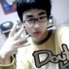 a young man wearing glasses is making a hand gesture with the words double k in front of him