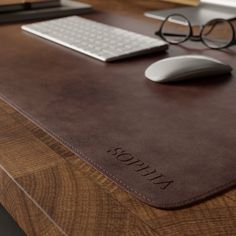 a computer mouse pad sitting on top of a wooden desk