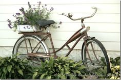 an old bicycle with flowers in the basket