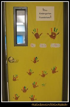 a yellow door with handprints on it