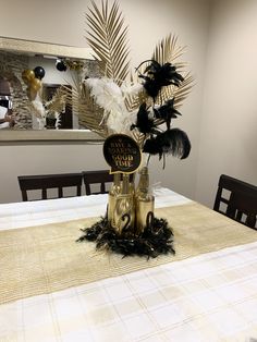 the table is set with black and gold decorations