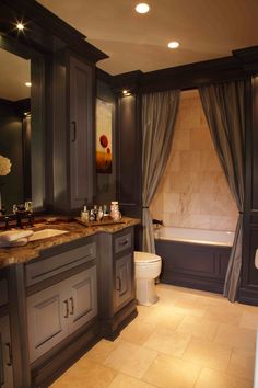 a large bathroom with two sinks and a tub