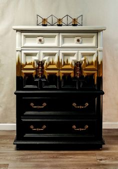 a black and white dresser with gold accents