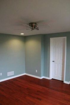 empty room with hard wood flooring and ceiling fan