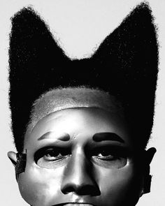 a black and white photo of a man with his hair in the shape of a cat's head