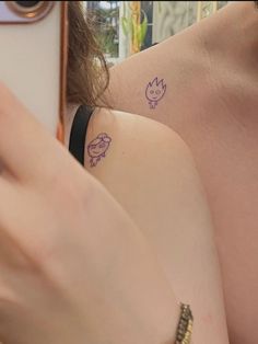 two women with matching tattoos on their backs