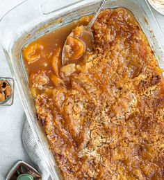 a casserole dish with meat and gravy in it on a table