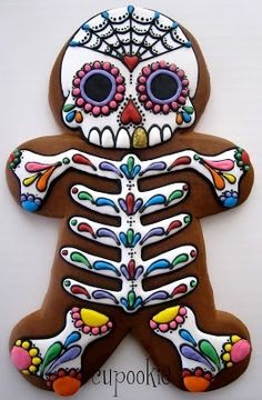 a decorated sugar cookie with a human skeleton on it's body and hands in the shape of a man