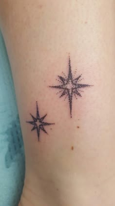 a small star tattoo on the side of a woman's lower back ribcage