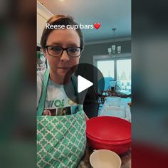 a woman wearing glasses and an apron holding a red bowl