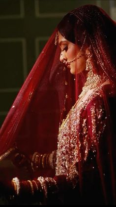 a woman in a red and gold wedding outfit