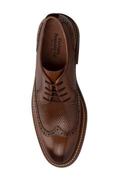 Herringbone pattern woven details meet a wingtip toe silhouette to create this unique lace-up. Round wingtip toe Broguing details Woven texture details Lace-up Leather upper, manmade sole Imported Vintage Brown Lace-up Business Shoes, Brown Wingtip Oxfords With Laces, Wingtip Oxfords With Laces, Vintage Oxfords For Formal Occasions, Vintage Formal Oxfords With Laces, Vintage Brown Lace-up Shoes With Brogue Detailing, Vintage Lace-up Shoes With Brogue Detailing And Pointed Toe, Classic Wingtip Dress Shoes With Laces, Brown Wingtip Oxfords With Textured Sole