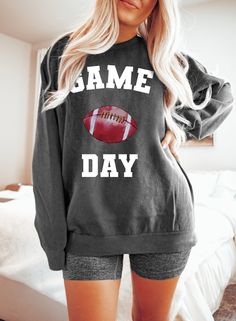 "Football Sweatshirt, Comfort Colors®, Game Day Sweatshirt, Football Team, Sports Sweatshirt, College Football, Football Lover, Football Mom WELCOME TO BUTIKCHI  This sweatshirt perfect gift as a holiday apparel. Ideal for any situation, a unisex heavy blend crewneck sweatshirt is pure comfort. How to Order?  Please, choose your favorite color and size from the pop-up window. Select the quantity that you want. Click \"ADD TO CART\". You can go back to add more product color for your loved ones members.  You can complete the checkout process. Please \"Click Proceed to Check Out\" Finally, you have completed all the steps, your product will be prepared to be shipped. Washing Care Instructors Use cold water when washing, do not use bleach, do not dry clean, and do not use an iron directly on Game Day Long Sleeve Hoodie With Graphic Print, Long Sleeve Tops For Sports Events, Fall Sports Fan Tops With Letter Print, Sports Fan Letter Print Tops For Fall, Sports Fan Tops With Letter Print For Fall, School Spirit Long Sleeve Tops For Football Season, Fall Crew Neck Tops For Sports Events, Long Sleeve T-shirt For Sports Events In Fall, Fall Long Sleeve T-shirt For Sports Events