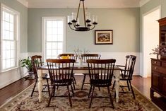 a dining room table with chairs and a chandelier