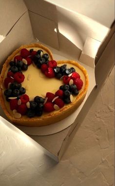 a heart shaped cheesecake with berries and blueberries