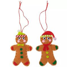 two christmas gingers hanging from strings on a white background with red and green decorations