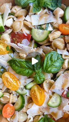 a bowl filled with pasta and vegetables on top of a table